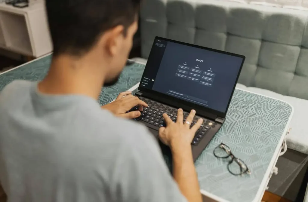 A person uses ChatGPT on a laptop, symbolizing the growing interaction between humans and artificial intelligence following OpenAI’s recent policy changes.