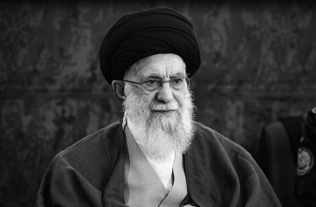 Formal portrait of Ali Khamenei wearing a black turban and glasses