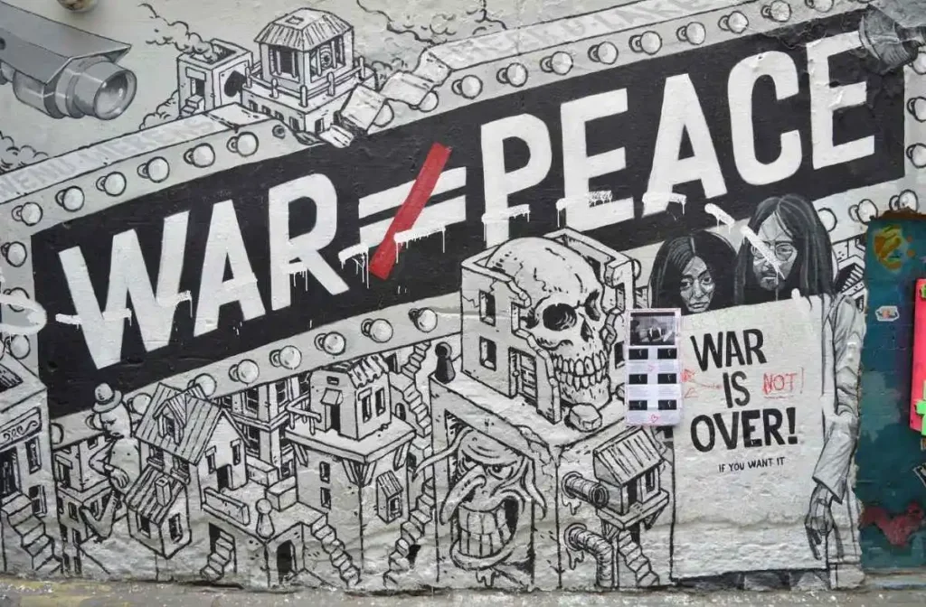 Graffiti artwork depicting fragile peace after US-Iran armistice with the message War equals Peace crossed out and War is Not Over