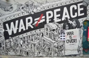 Graffiti artwork depicting fragile peace after US-Iran armistice with the message War equals Peace crossed out and War is Not Over